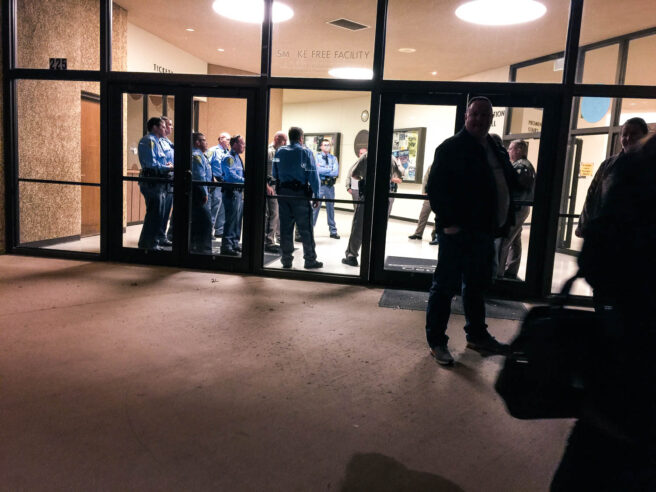 Police having a meeting in the lobby of the rally entrance.